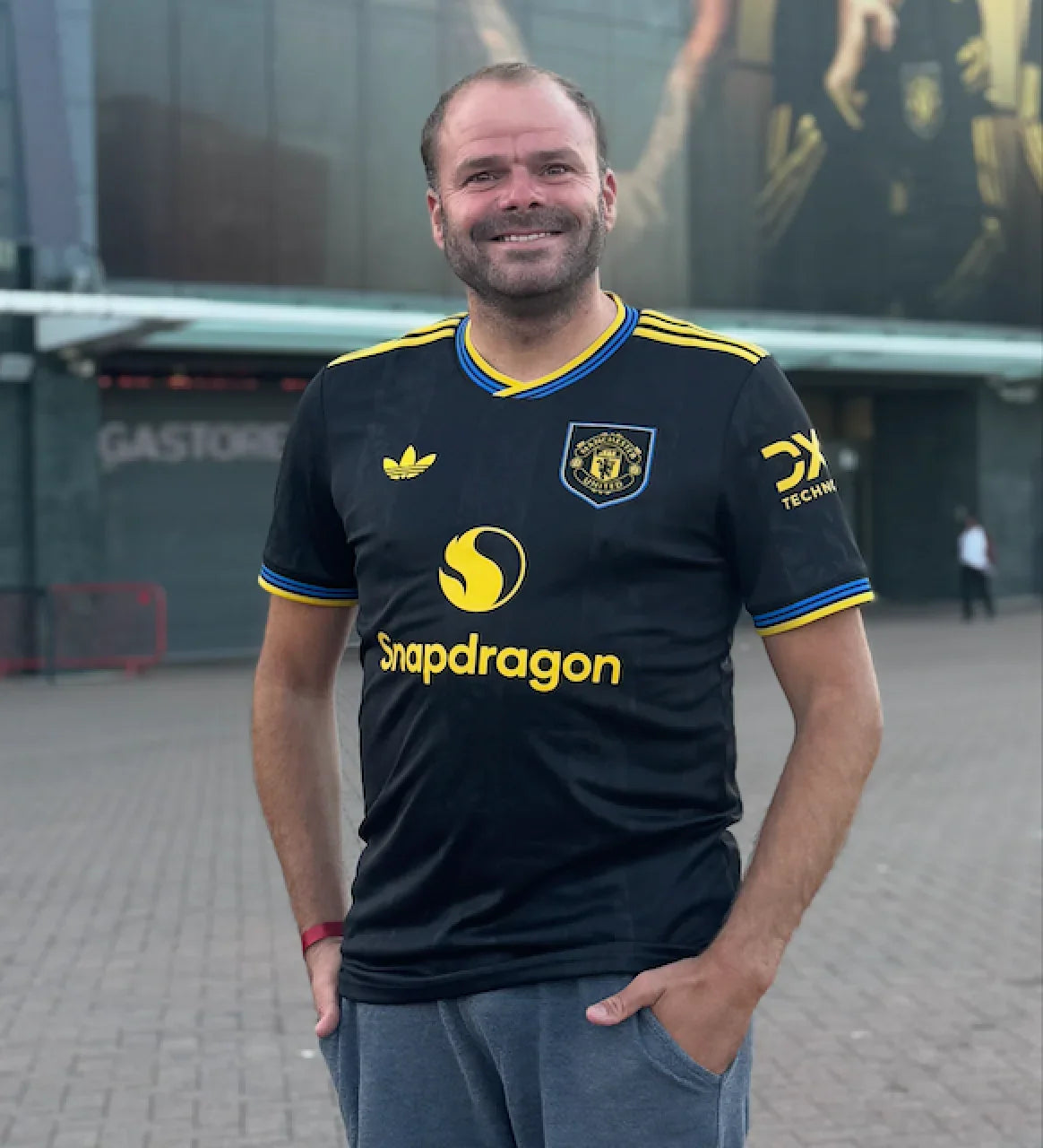 Jeffrey, founder of Iconic Shirts, outside a stadium